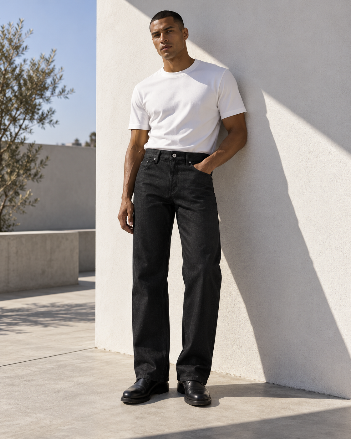 VIKTR MARTIN black wide-leg jeans styled with a white T-shirt in a sunlit architectural courtyard — editorial visualization